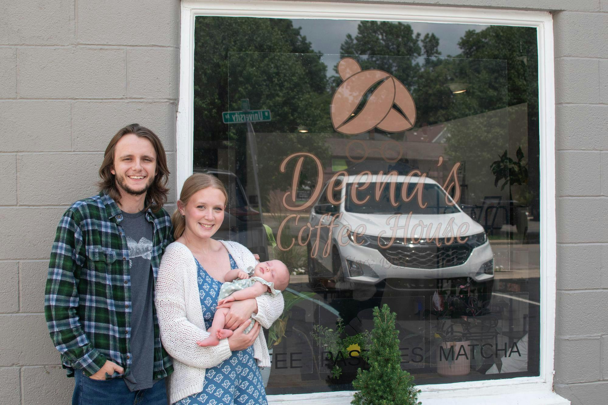 Deena's Coffee House owners Alyssa and James Helfer with their daughter, Ruby, photographed outside of their shop, June 25 in Muncie, Indiana. Kylee White, DN Photo.