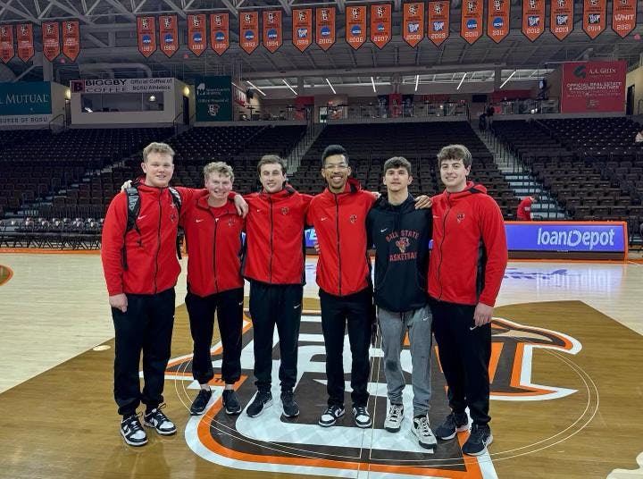 The Ball State men's basketball managers stand mid-court March 8 at the Stroh Center at Bowling Green University. Ball State Athletics, provided.