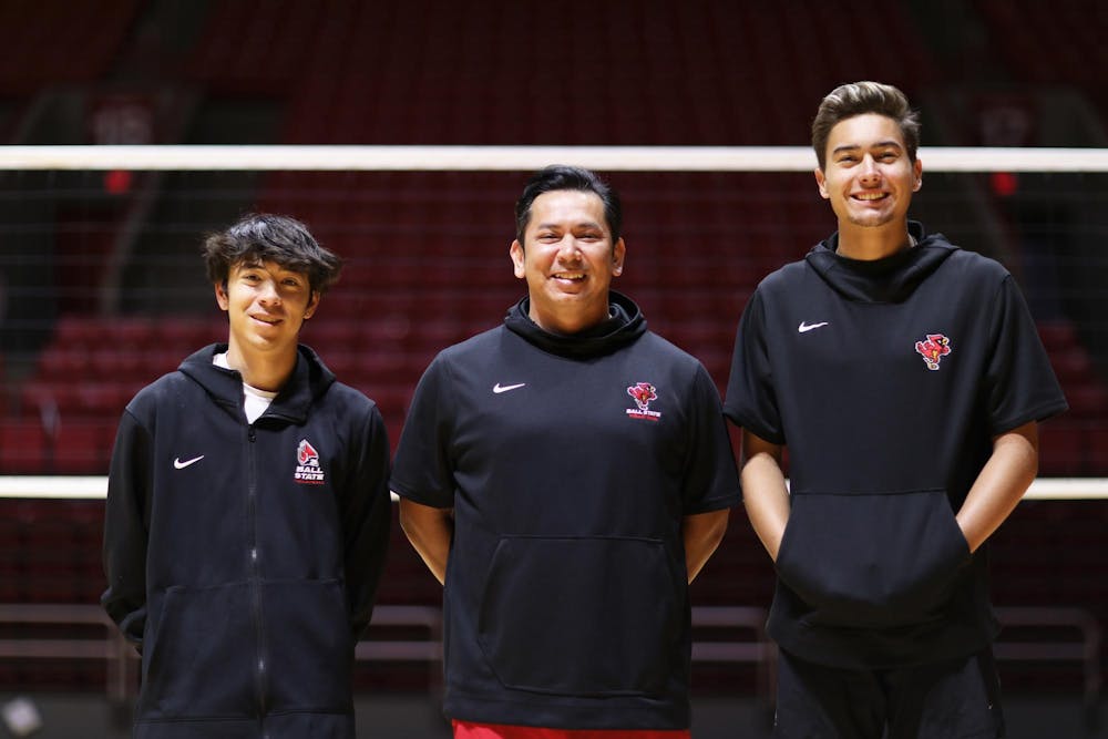 <p>Junior libero Xander Pink (left), Head Coach Donan Cruz (middle) and Sophomore opposite hitter Keau Thompson (right) pose for a photo March 26 at Worthen Arena. The head coach and pair of players have helped lead Ball State men’s volleyball to a recent resurgence. Mya Cataline, DN</p>
