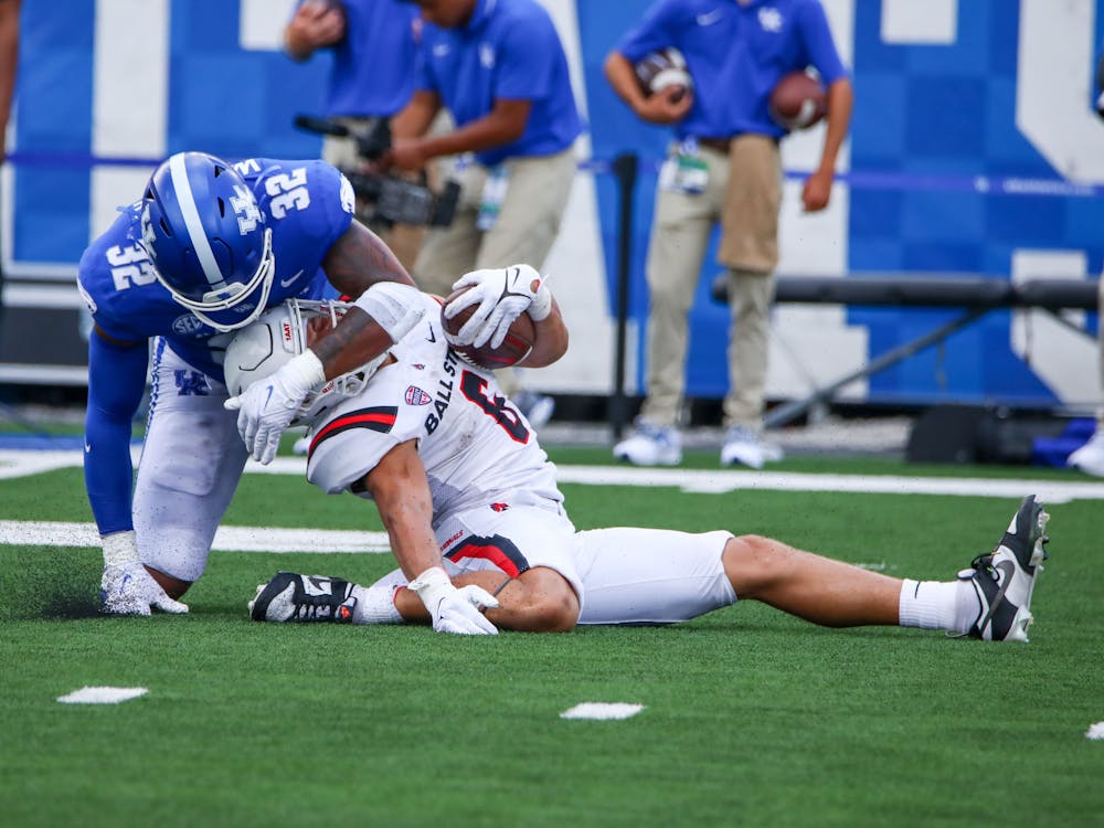 Redshirt sophomore running back Vaughn Pemperton gets tackled during a rushing attempt against Kentucky Sept. 2 at Kroger Field in Lexington, Ky. Pemperton would be helped off the field immediately following the play and would not return for the remainder of Ball State’s 44-14 loss to the Wildcats. Daniel Kehn, DN