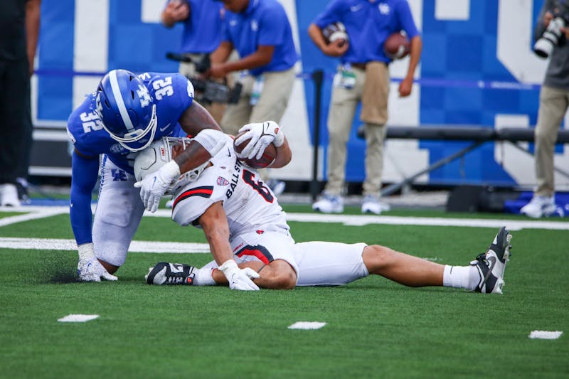 Redshirt sophomore running back Vaughn Pemperton gets tackled during a rushing attempt against Kentucky Sept. 2 at Kroger Field in Lexington, Ky. Pemperton would be helped off the field immediately following the play and would not return for the remainder of Ball State’s 44-14 loss to the Wildcats. Daniel Kehn, DN