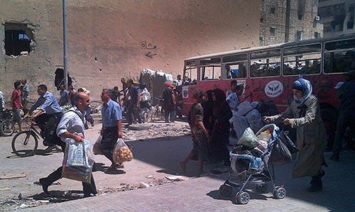 A woman carries groceries in a stroller back to the government-controlled neighborhoods in Aleppo, Syria. The U.S. government is calling for military involvement in the nation after a chemical warfare attack that targeted civilians. MCT PHOTO