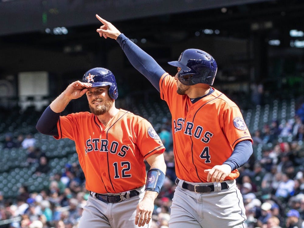The Houston Astros' George Springer (4) salutes Jose Altuve after he scored on Altuve's bases-loaded double in the fifth inning against the Seattle Mariners Thursday, April 19, 2018, at Safeco Field in Seattle. The Astros won, 9-2. (Dean Rutz/Seattle Times/TNS)