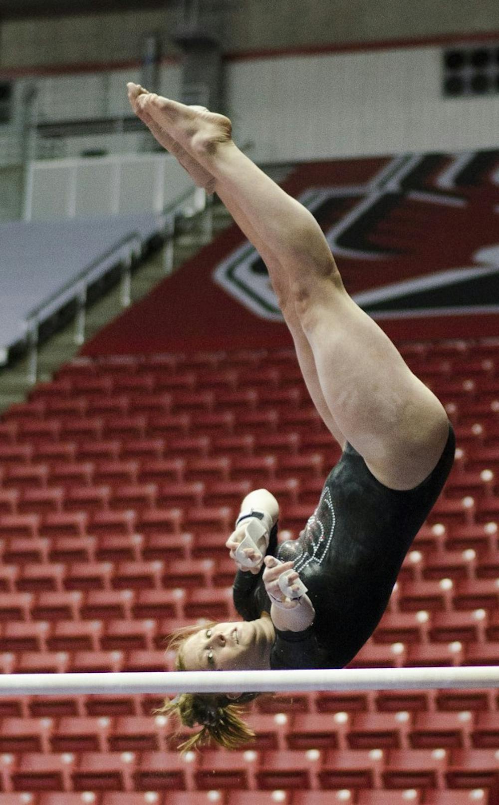 Senior Angela Durkac performs her routine in the unparallel bars during the meet against Eastern Michigan and Illinois State on Jan. 24 in Worthen Arena. DN PHOTO BREANNA DAUGHERTY