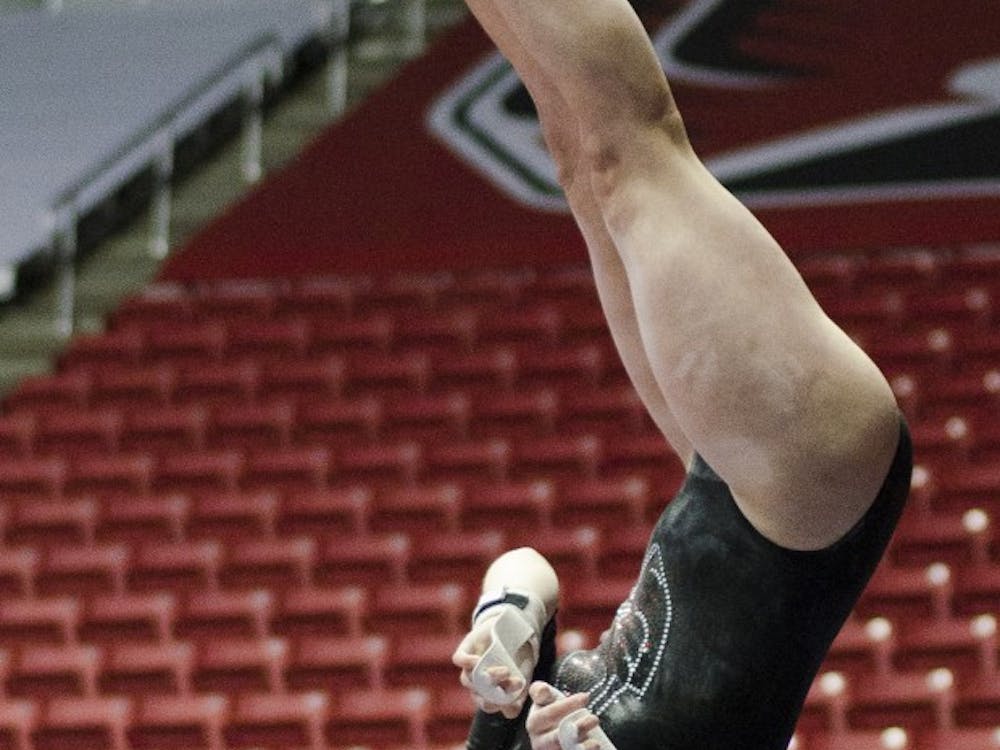 Senior Angela Durkac performs her routine in the unparallel bars during the meet against Eastern Michigan and Illinois State on Jan. 24 in Worthen Arena. DN PHOTO BREANNA DAUGHERTY
