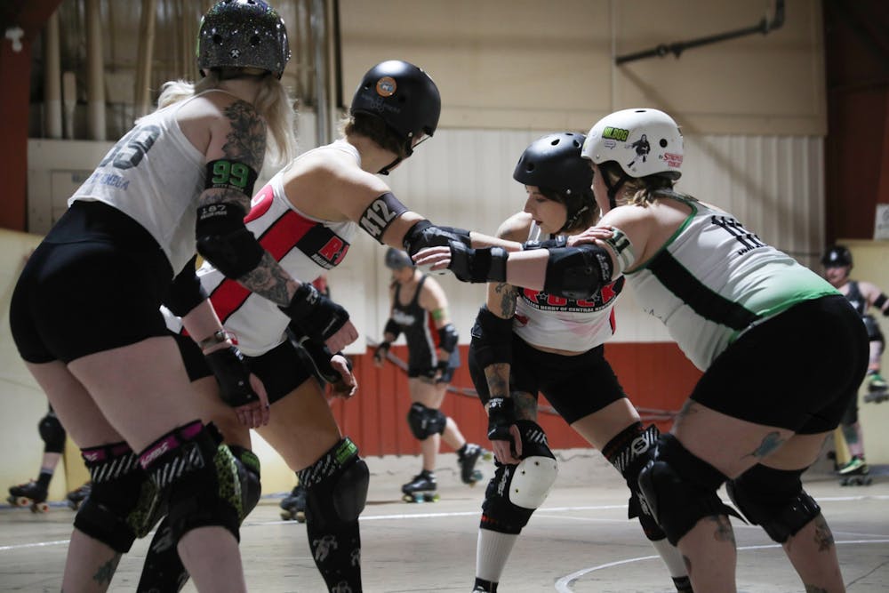 Team Kentucky blocks and prepares for Team Indiana's jammer to try to get through them Dec.10 at the Delaware County Fairgrounds. In roller derby, jammers are the only ones who get points for their team by passing the blockers. Elissa Maudlin, DN