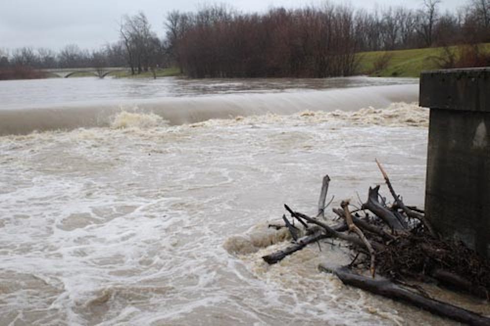 Water flows down the White River near McCulloch Park on Jan. 13. The water reached 9 feet around 4:30 p.m. Sunday afternoon. The river is experiencing minor flooding, according to the National Weather Service. DN PHOTO TAYLOR IRBY