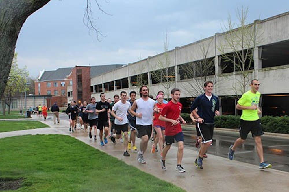 Runners for the Unity Run move past Noyer Complex on April 18, 2013 to show their support for the victims of the Boston Marathon bombing. Justin Miller and Josh Fern from the Ball State Runners Association planned the event, and one student who grew up near Boston participating in the run. DN PHOTO TAYLOR IRBY