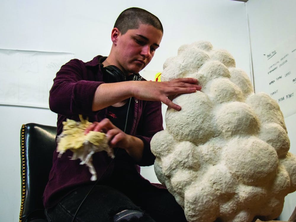 Siena Hancock cleans out a mask she is creating April 23, 2019, in PlySpace in Muncie, Indiana. PlySpace is an immersive residence program where artist can create and showcase their work. Eric Pritchett, DN