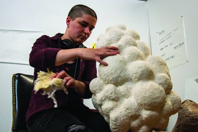 Siena Hancock cleans out a mask she is creating April 23, 2019, in PlySpace in Muncie, Indiana. PlySpace is an immersive residence program where artist can create and showcase their work. Eric Pritchett, DN