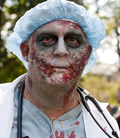 John Lee stares down the camera while in makeup for the Zombie Walk. Ball State’s campus looked and sounded like a horror movie Aug. 25 as bloody creatures rambled through the streets at the Muncie Zombie Walk. The charity walk collected donations for Muncie Animal Rescue Fund and Second Harvest Food Bank. More than 350 people attended, bringing 865 pounds of food for Second Harvest and 204 pounds of pet supplies for ARF, said Robert Abner, an organizer of the event, on the Facebook event page. DN FILE PHOTO BOBBY ELLIS