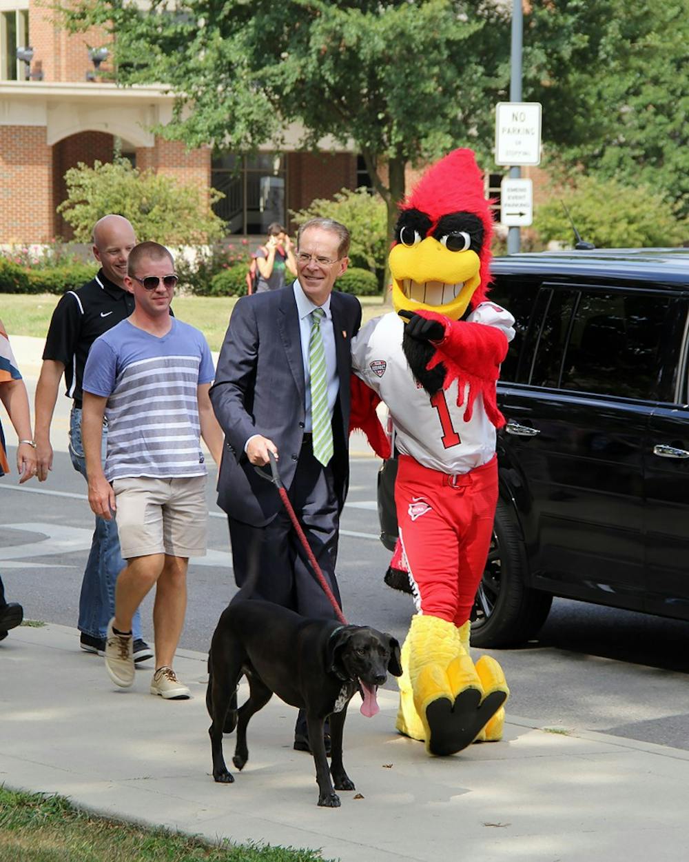 President Mearns and Charlie Cardinal pose for a photo while walking down N. McKinley Ave. on Wednesday, Aug. 30, 2017 for the kickoff of the On the Road with the Cardinals fitness program. Faculty and staff enrolled in the program have 68 days to “walk” the distance to Cardinals’ away football games during the 2017 season. Paige Grider, DN