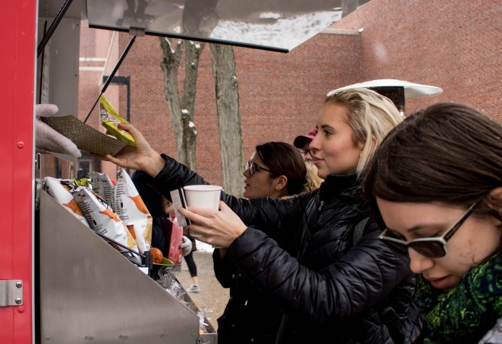 <p>Students purchase food from the Ball State mini food truck March 13, 2018. The truck will continue to sell food at various locations on campus through the month of October. <strong>Rebecca Slezak, DN</strong></p>