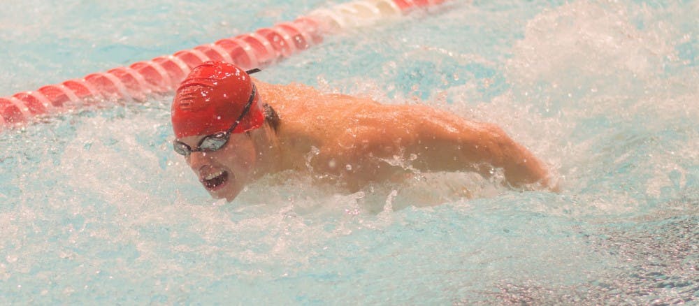 <p>Krent Hueni swims the 100 yard butterfly during the meet against Tiffin on Nov. 11 in the Lewellen Aquatic Center. The Cardinals will be swimming in the Eastern Michigan invitational Dec. 1 and 2. Teri Lightning Jr., DN</p>