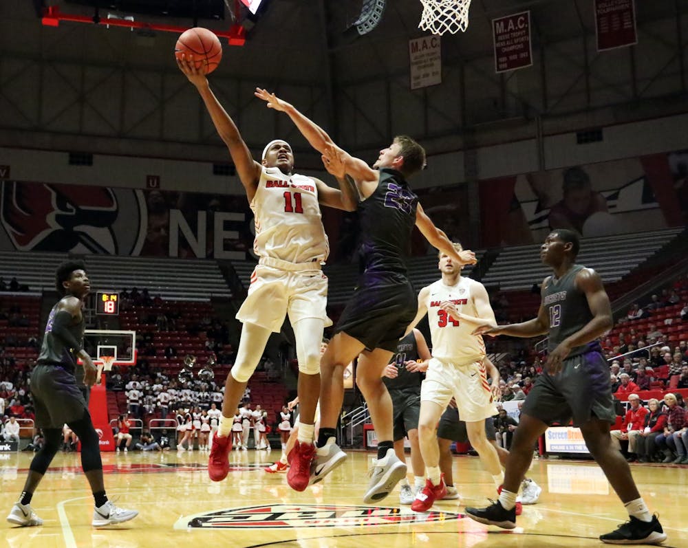 Ball State redshirt freshman guard Jarron Coleman goes for a layup while being guarded by Defiance freshman guard Chase Glock during the Cardinals' game against the Yellow Jackets Tuesday, Nov. 5, 2019, at John E. Worthen Arena. Ball State won 87-43. Paige Grider, DN