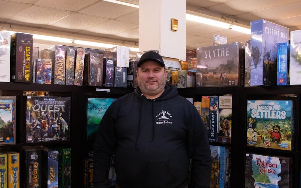 <p>Wizard’s Keep Game and Hobby store owner David Barnette poses in front of a shelf in the store. Before Barnette became the owner he worked at the store in the 1990s while attending Ball State University. Hannah Amos, DN</p><p><br></p><p><br></p><p><br></p>