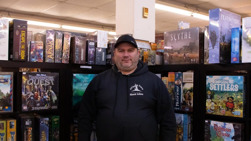 Wizard’s Keep Game and Hobby store owner David Barnette poses in front of a shelf in the store. Before Barnette became the owner he worked at the store in the 1990s while attending Ball State University. Hannah Amos, DN