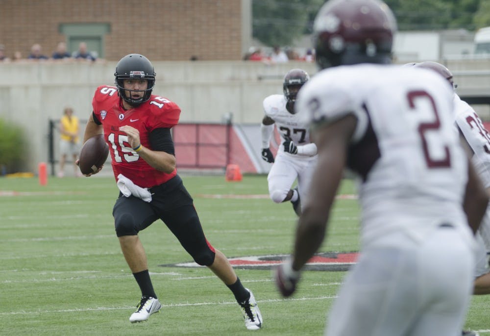 Redshirt sophomore quarterback Ozzie Mann runs the ball during the game against Colgate on Aug. 30 at Scheumann Stadium. DN PHOTO BREANNA DAUGHERTY 