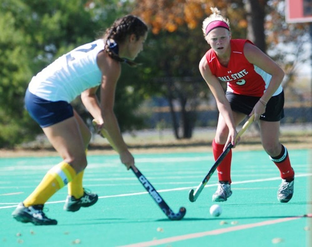 Ball State's Devanny Kuhn, right, fights for the ball from Kent State's Stephanie Arbelaez during their game on Sunday. Ball State lost to Kent State 7-4. DN PHOTO CATHERINE THOMPSON