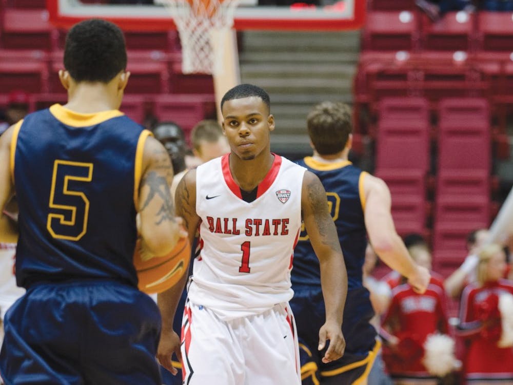Freshman point guard Zavier Turner eyes an opponent for an opening during the Nov. 4 game against Marian. Turner started off the season by scoring 17 points in each of the first three games of the season, but fell short during the Cardinals