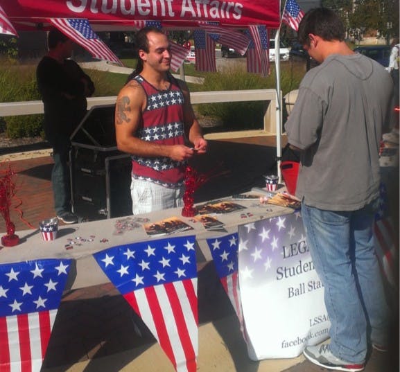 Adom Scott Silberman (left) hands out Constitution-related items to students. 