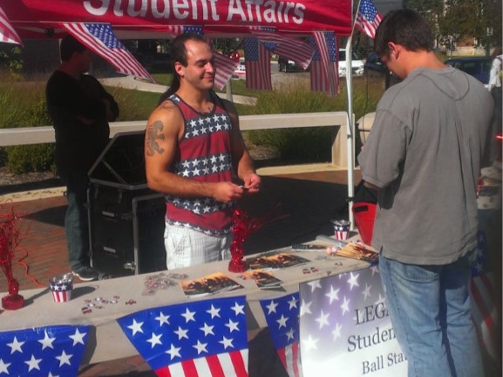 Adom Scott Silberman (left) hands out Constitution-related items to students. 