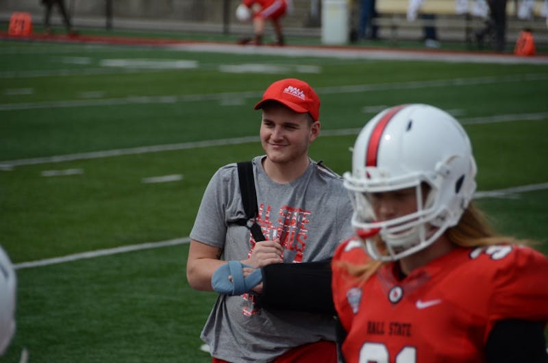 Redshirt freshman Trey Uetrecht stands and smiles on the sidelines with his teammates during the Ball State spring game on April 13 at Scheumann Stadium. The team has rallied around Uetrecht after a car accident that left him critically injured. Zach Piatt, DN&nbsp;