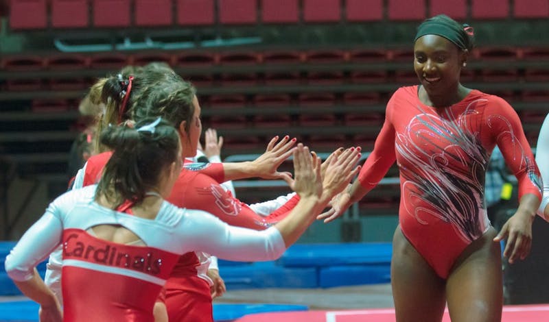 Freshman Tia Kiaku high fives her teammates after completing her floor routine during the Red vs. White meet on Dec. 4 in John E. Worthen Arena. The next home gymnastics meet will be Jan. 28 against Kent State University. Teri Lightning Jr., DN