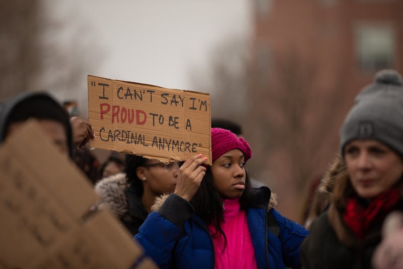 A supporter holds a sign, Jan. 28, 2020, at University Green on Ball State's campus. The sign reads a quote from Sultan "Mufasa" Benson, senior business administration major, who had University Police Department officers called on him Jan. 21, 2020, by Shaheen Borna, marketing professor at Ball State, for refusing to change seats during class. Jacob Musselman, DN