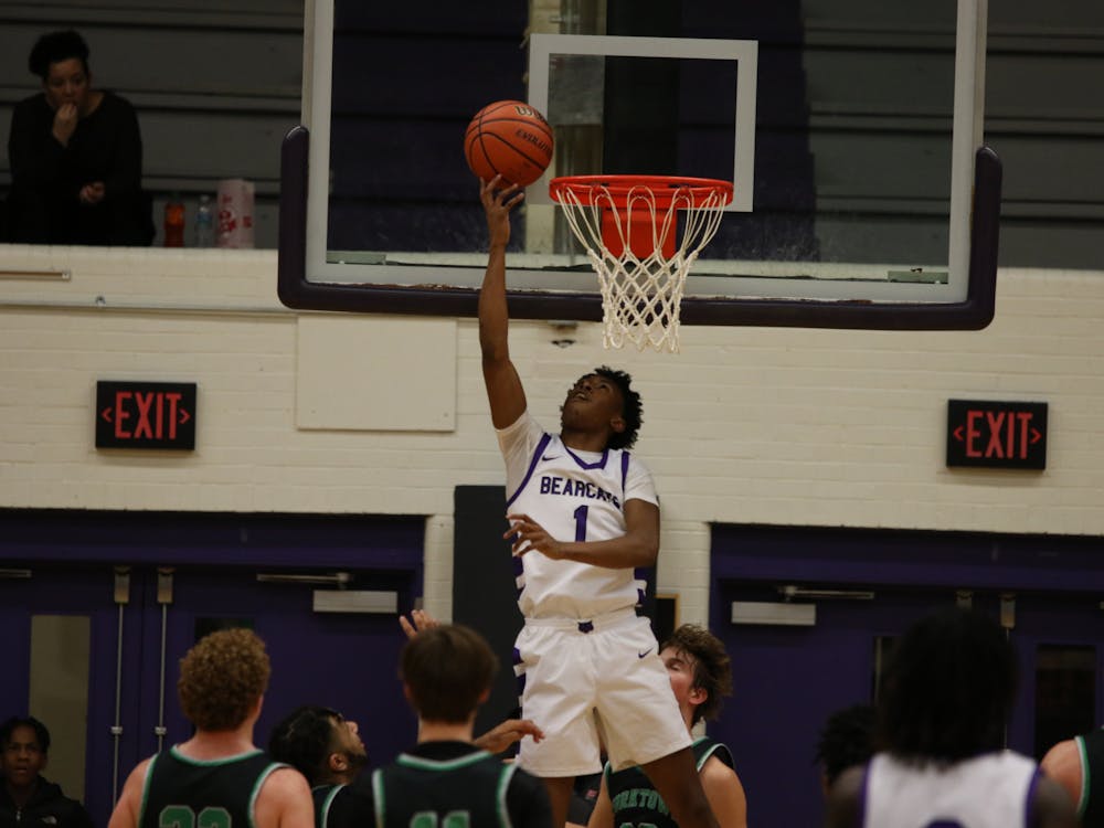 Bearcats senior guard Daniel Harris attempts a layup Feb 14. at Muncie Central Fieldhouse. He would go on to hit the game-winning three-pointer. Zach Carter, DN