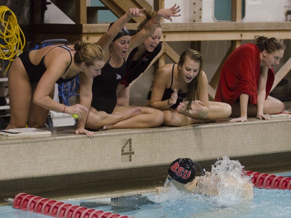 Members of Ball State women's swimming and diving team cheer on fellow teammate senior Bridgette Ruehl in the 200-yard breaststroke against Miami University on Nov. 8 at Lewellen Aquatic Center. DN PHOTO BREANNA DAUGHERTY 