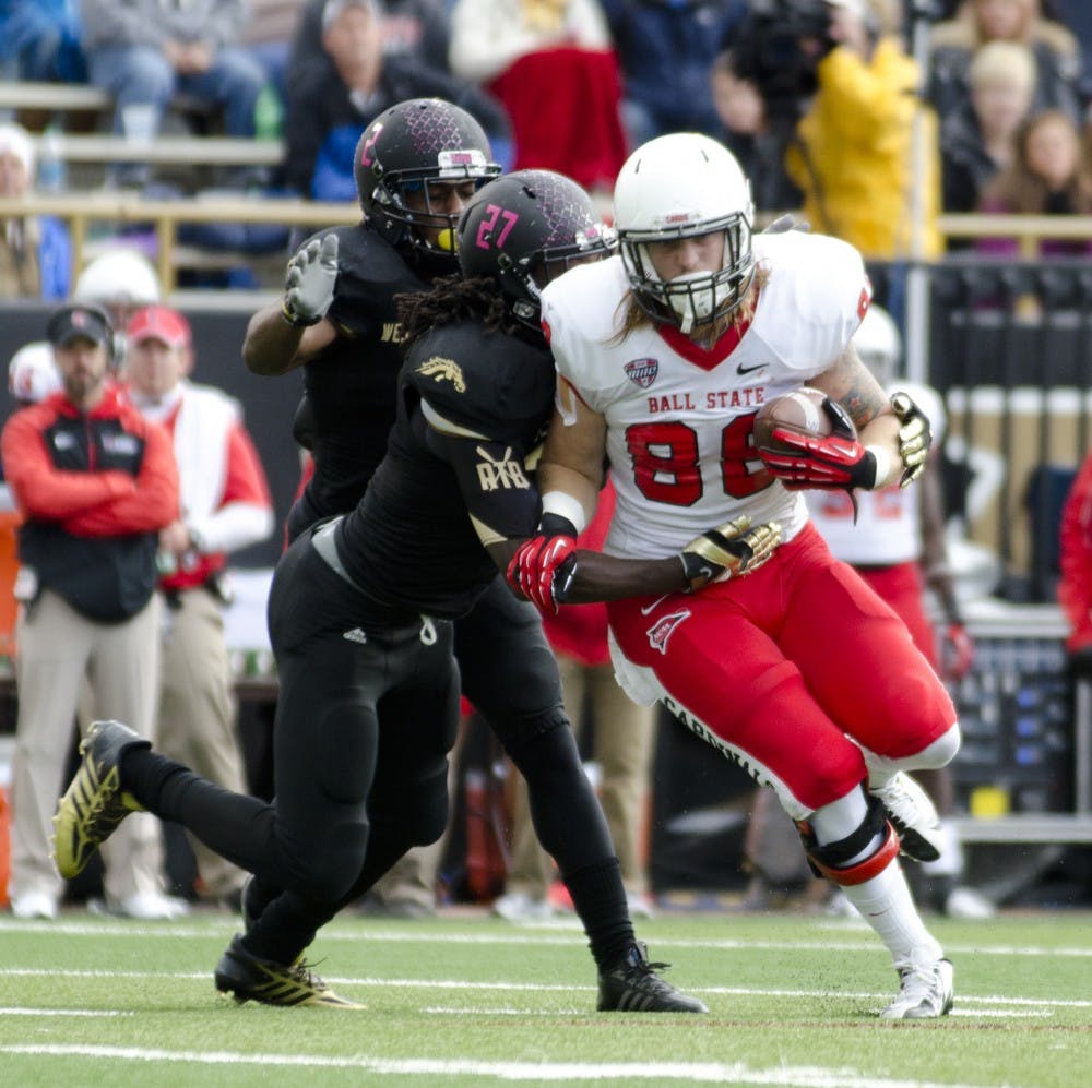 	Senior tight end Zane Fakes tries to break free from a Western Michigan University defender at Waldo Stadium on Oct. 19. Fakes had six catches for 54 yards on his birthday.