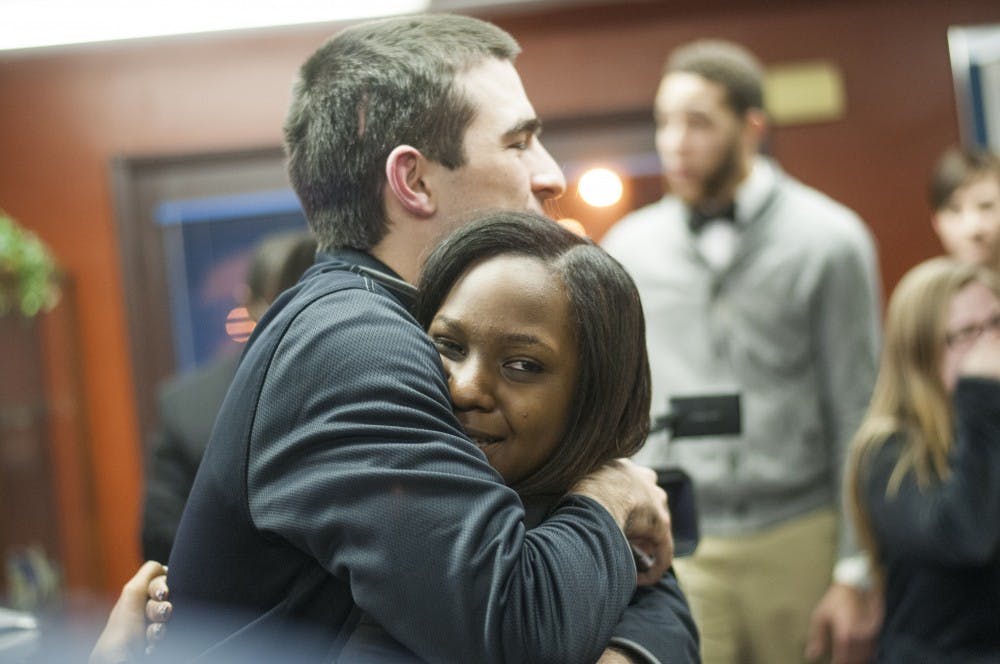 Rahissa Engle, Cardinal Connection secretary, embraces a supporter after winning the SGA election Feb. 25. DN PHOTO JONATHAN MIKSANEK