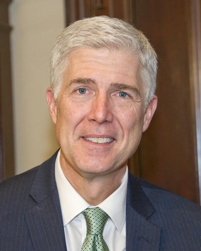 Judge Neil Gorsuch, U.S. President Donald J. Trump's Supreme Court nominee, as he makes a courtesy call on U.S. Sen. Mark Warner (D-Va.) on Feb. 14, 2017 in the senator's Capitol Hill office in Washington, D.C. (Ron Sachs/CNP/Zuma Press/TNS)