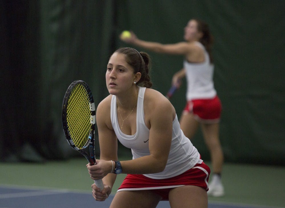 Senior Carmen Blanco watches her opponents while senior Tori Ormond serves against Wright State on Feb. 5. Emma Rogers // DN