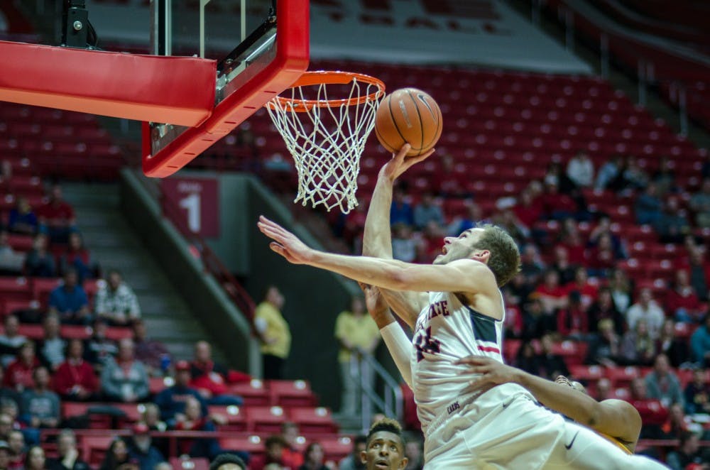Sophomore forward Kyle Mallers jumps up for a layup while being grabbed by a Kent State opponent Feb. 9 at John E. Worthen Arena. Ball State won the game 87-68. Stephanie Amador, DN