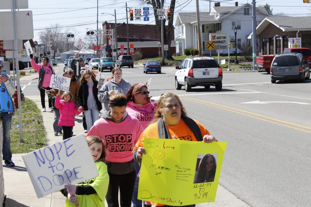 Activists walk through Austin, Ind., chanting "Nope to dope!" A recent HIV outbreak lead the Indiana governor to declare a state of emergency there. (Sarah Parvini/Los Angeles Times/TNS)