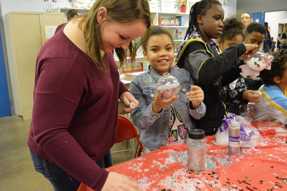 <p>Ball State students helped out at the Muncie Boys and Girls Club on Dec. 11 at the Angel Fest&nbsp;event. Kids did crafts and played games with their "angel buddy" at the event. DN PHOTO ALLIE KIRKMAN</p>