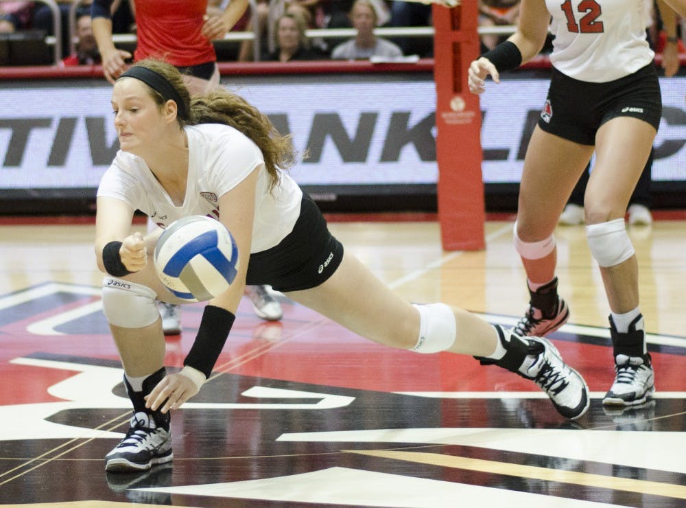 Freshman middle blocker Emily Holland attempts to save the ball in the second game of the Active Ankle Tournament against Belmont on Aug. 28 at Worthen Arena. DN PHOTO BREANNA DAUGHERTY