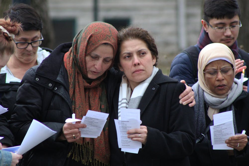 <p>Bibi Bahrami, president of the Islamic Center of Muncie, and Susana Rivera-Mills, provost and executive vice president for academic affairs, comfort each other at the candlelight vigil March 21, 2019, in front of the Beneficence Statue. Bahrami thanked the crowd for coming and the university for supporting the local Muslim community. <strong>Jacob Musselman, DN</strong></p>