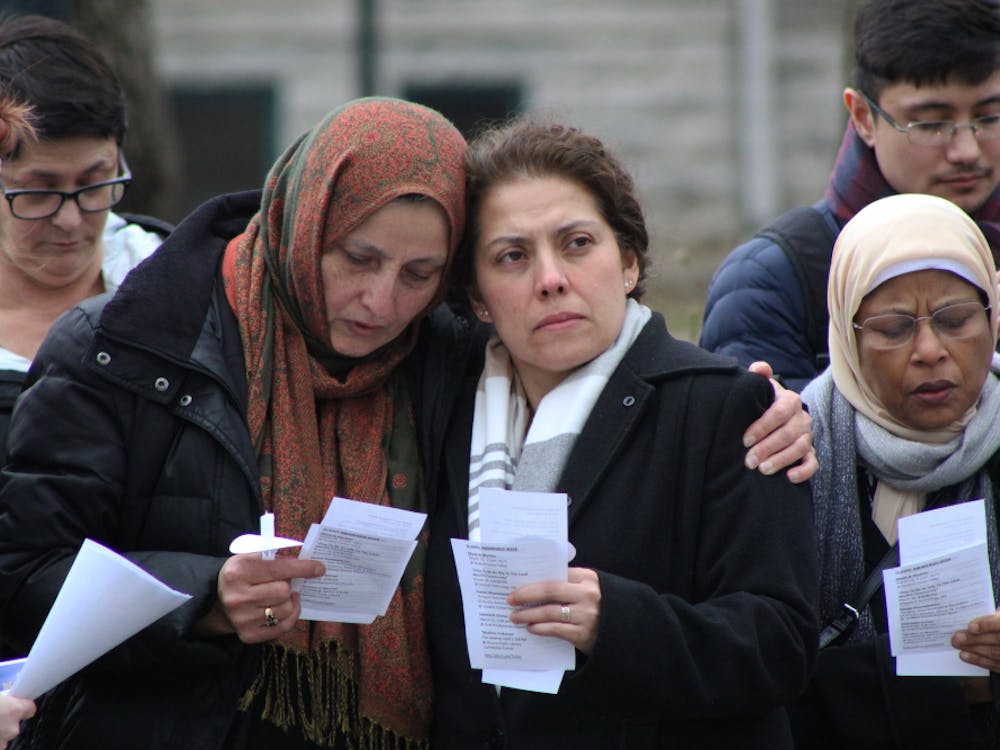 Bibi Bahrami, president of the Islamic Center of Muncie, and Susana Rivera-Mills, provost and executive vice president for academic affairs, comfort each other at the candlelight vigil March 21, 2019, in front of the Beneficence Statue. Bahrami thanked the crowd for coming and the university for supporting the local Muslim community. Jacob Musselman, DN