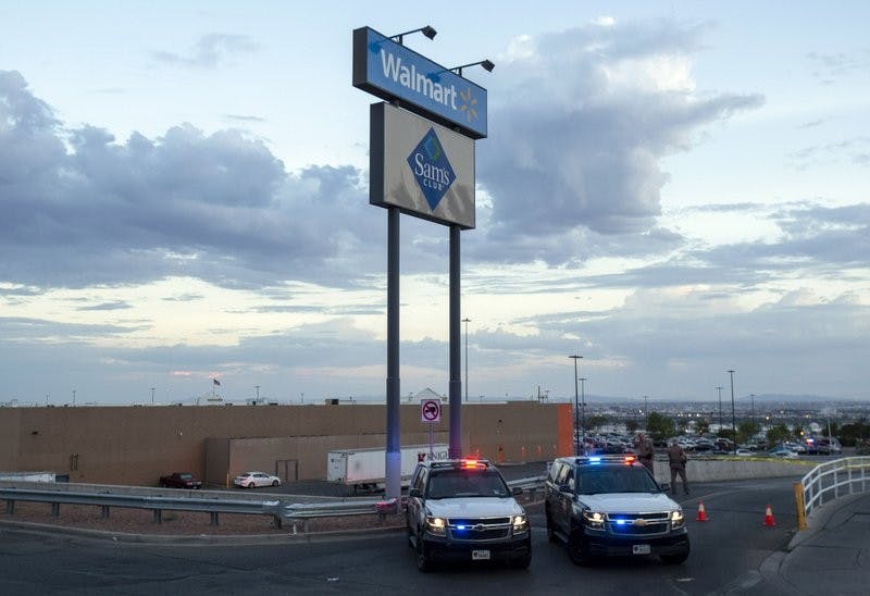 FILE - In this Aug. 3, 2019, photo texas state police cars block the access to the Walmart store in the aftermath of a mass shooting in El Paso, Texas. The Bentonville, Arkansas-based discounter says Tuesday, Sept. 3, that it will be discontinuing the sale of short-barrel and handgun ammunition. (AP Photo/Andres Leighton, File)