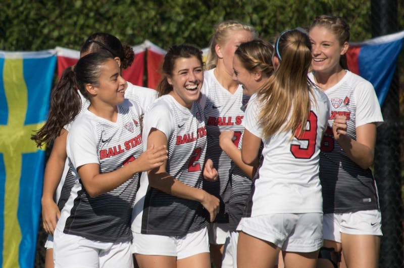 Ball State University players celebrate after Amanda Shaw scores in the second minute of the game against Eastern Michigan University at Briner Sports Complex on Oct. 13. Ball State won the game 3-0. Rebecca Slezak,DN File
