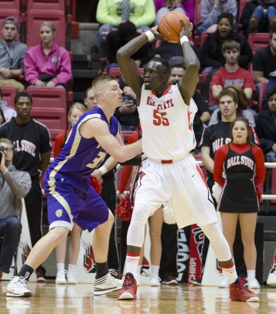 Senior center Majok Majok keeps the ball away from a Taylor University player on Nov. 12 at Worthen Arena. DN PHOTO BREANNA DAUGHERTY