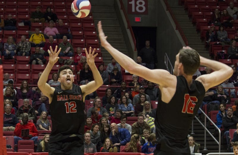Ball State men’s volleyball player Jake Romano, 12, sets up the ball for Matt Walsh, 16, to spike it during the first game against Loyola University on Feb. 17 at John E. Worthen Arena. &nbsp;Loyola was the second top 10 opponent that Ball State defeated. Briana Hale, DN