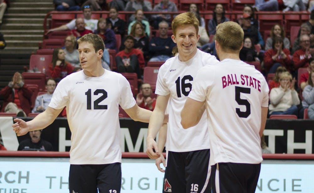 Senior middle attacker Kevin Owens high fives senior setter Graham McIlvaine after getting a kill in the third set against Ohio State on March 23 at Worthen Arena. Owens had sixteen kills. DN PHOTO BREANNA DAUGHERTY