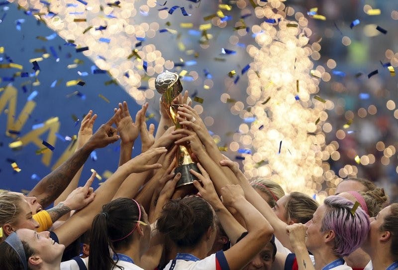 The United States players hold the trophy celebrating at the end of the Women's World Cup final soccer match between US and The Netherlands at the Stade de Lyon in Decines, outside Lyon, France, Sunday, July 7, 2019. The US defeated the Netherlands 2-0. (AP Photo/Francisco Seco)