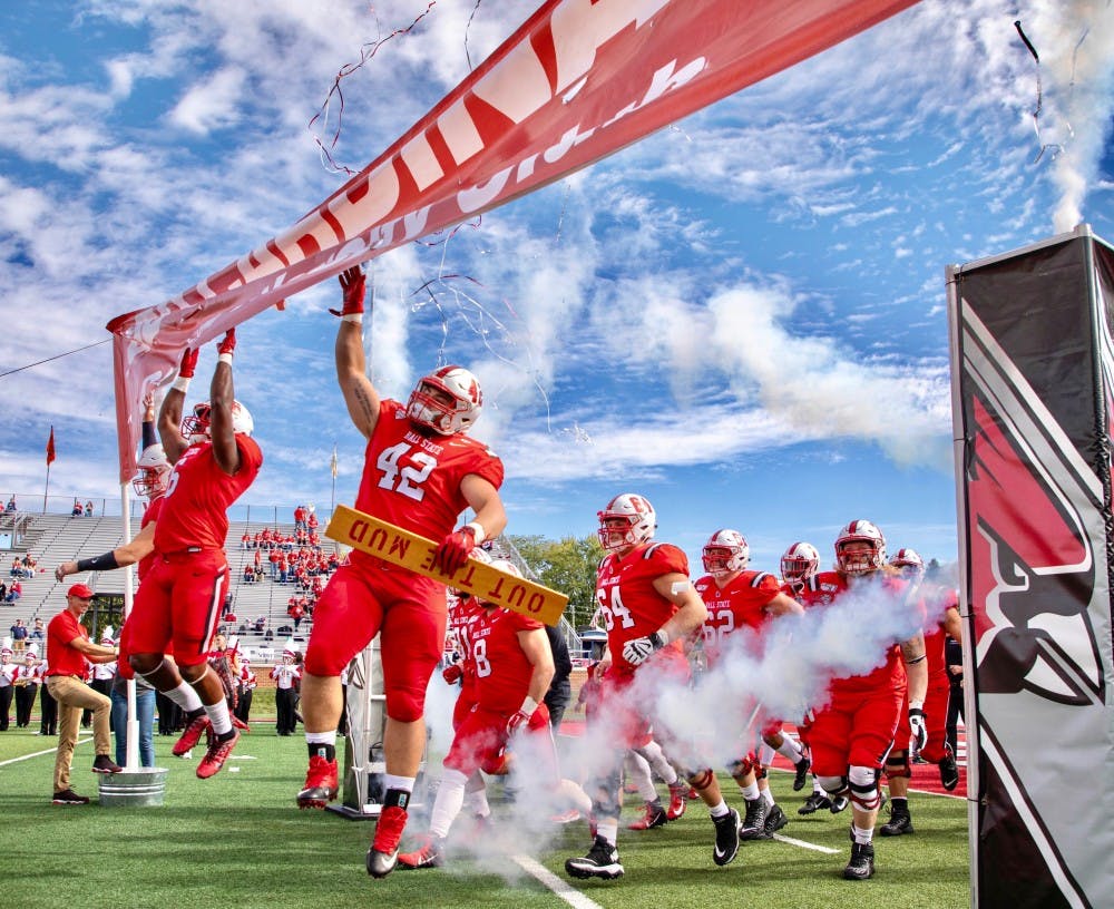 Senior defensive tackle Chris Crumb smacks the banner as he runs onto the field Oct. 19, 2019, at Scheumann Stadium. Ball State beat Toledo, 52-14. Jacob Musselman, DN