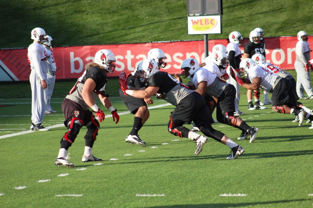 The Ball State Football Team practices hitting drills. During practice, as well as during games, athletes wear helmets in order to protect against concussions.
