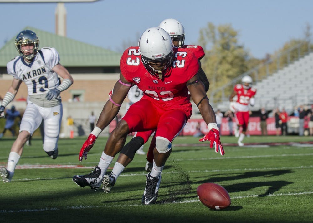 Sophomore running back Teddy Williamson goes to recover the ball during the game against Akron on Oct. 25 at Scheumann Stadium. DN PHOTO BREANNA DAUGHERTY